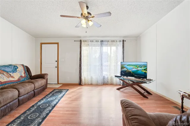 a bedroom with furniture and a flat screen tv
