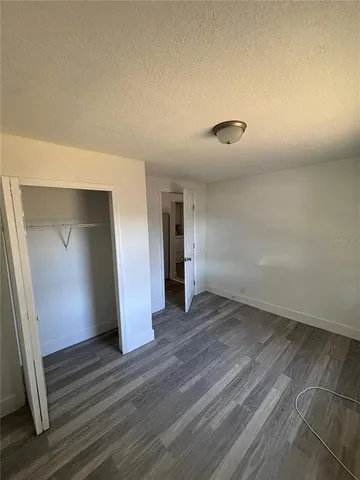 a view of a room with wooden floor and a window