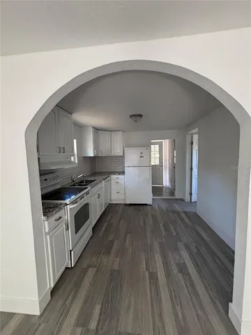 a kitchen with a white cabinets and white appliances
