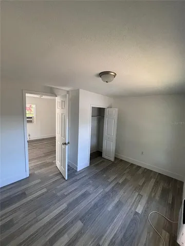 a kitchen with granite countertop a stove a sink and a refrigerator