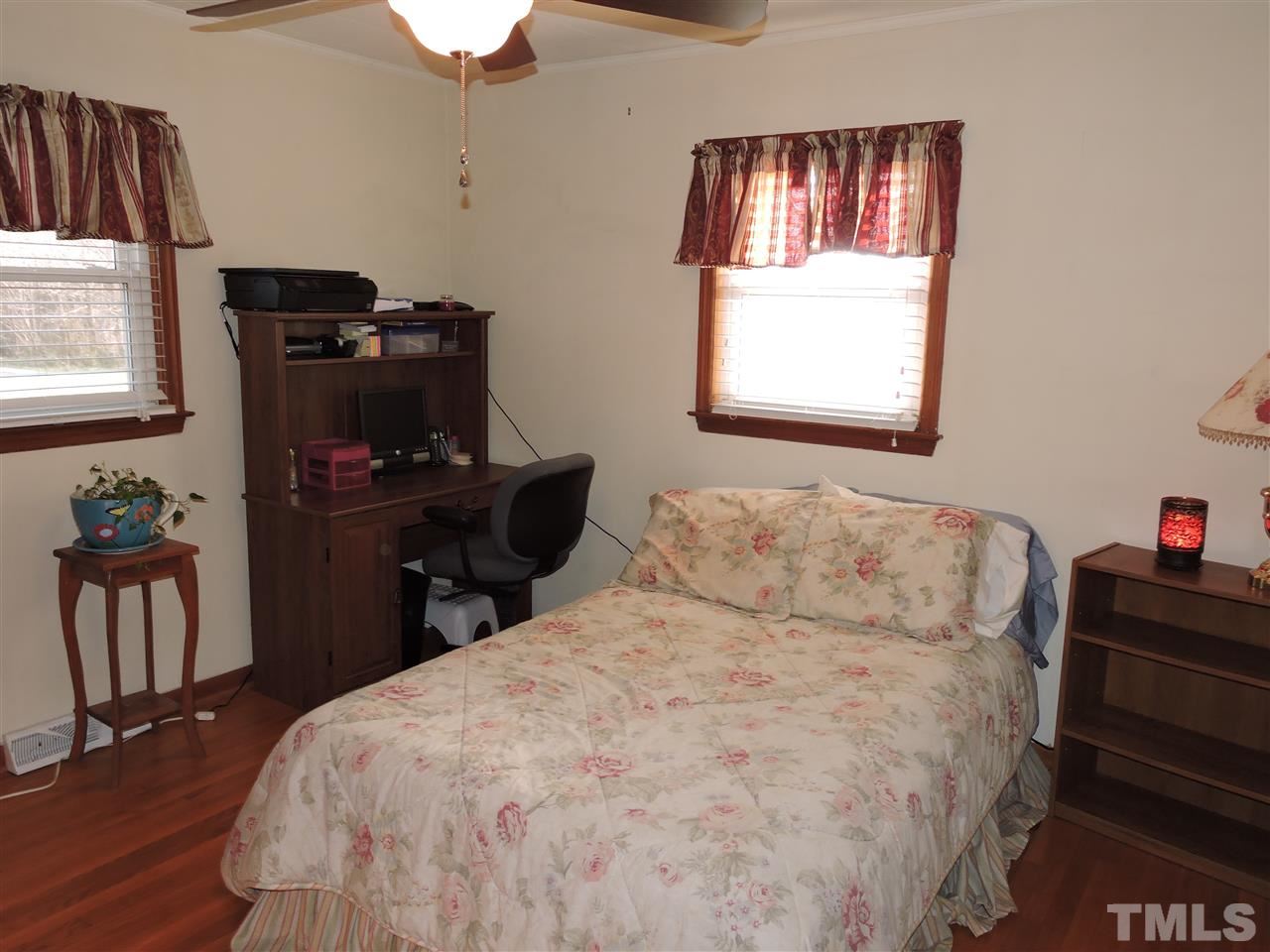505 Robertson Road Roxboro, NC 27574 - Photo 7 of 16 a bedroom with a bed and a window