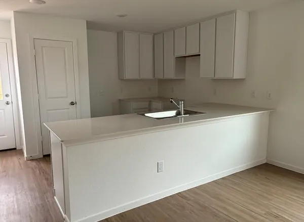 a room with a sink and cabinets
