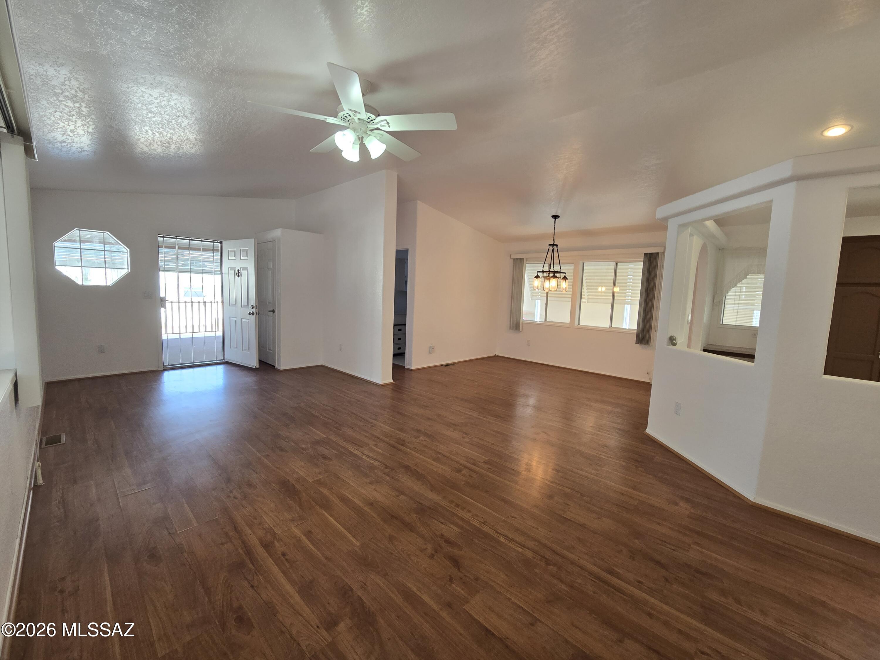 8401 South Kolb Road, Unit 61 Tucson, AZ 85756 - Photo 16 of 23 a view of an empty room with wooden floor and a window
