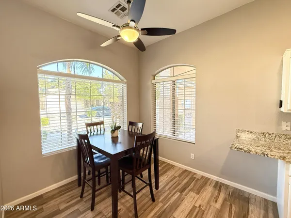 a dining room with furniture a chandelier and a window