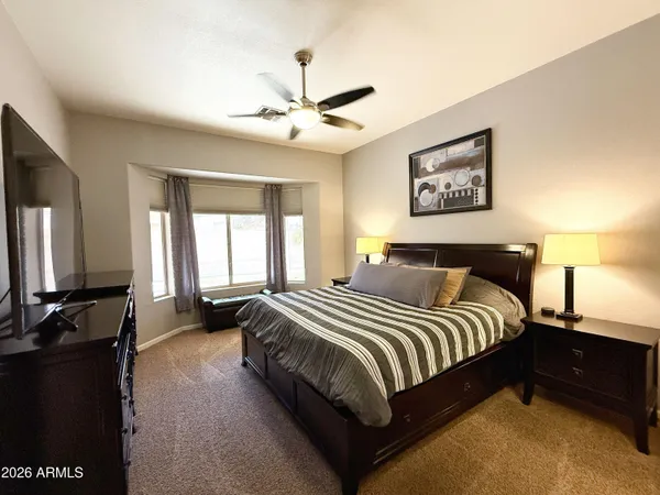 a bedroom with a bed and a chandelier