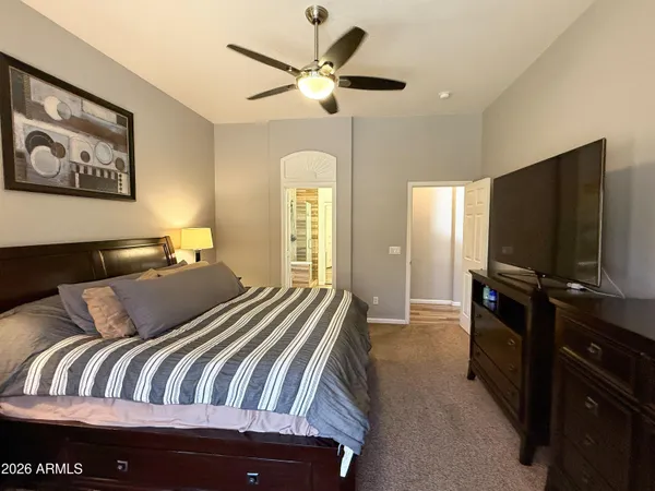 a bedroom with a bed and a flat screen tv