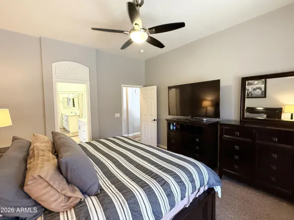 a bedroom with a bed and a flat screen tv