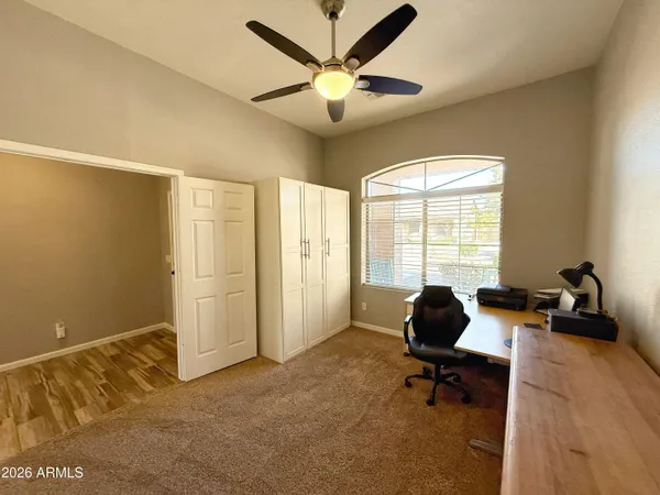 a work room with windows and ceiling fan