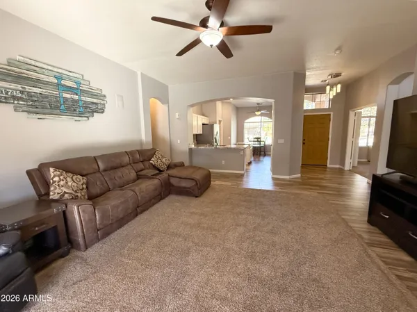 a living room with furniture and a chandelier