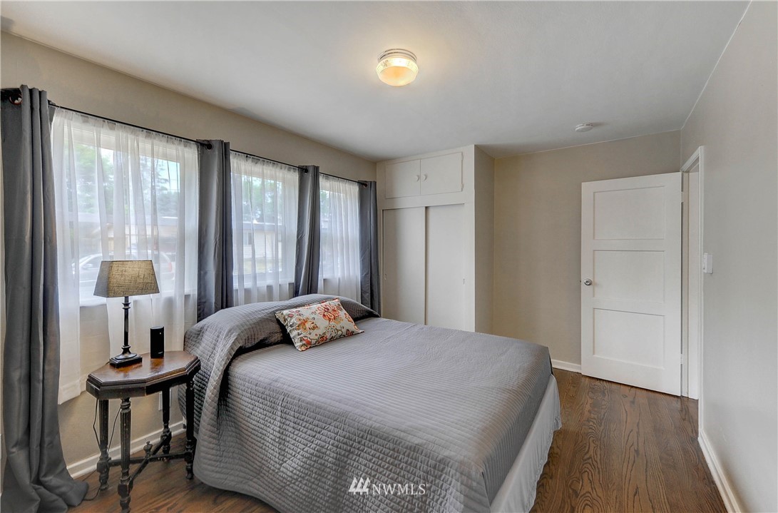 2713 Northeast 6th Place Renton, WA 98056 - Photo 14 of 22 a bedroom with a bed and a night stand