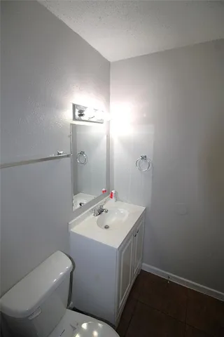 a bathroom with a sink a toilet and mirror