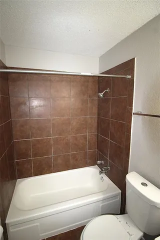 a bathroom with a toilet and bathtub