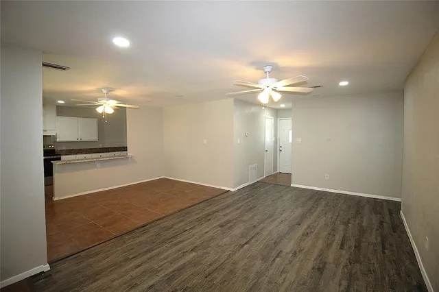 a view of an empty room and wooden floor