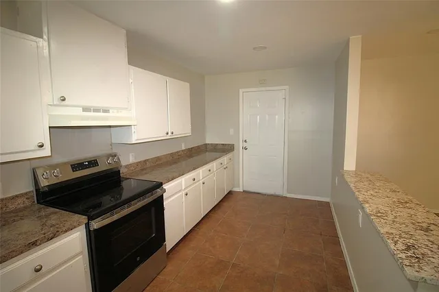 a kitchen with granite countertop cabinets and steel stainless steel appliances