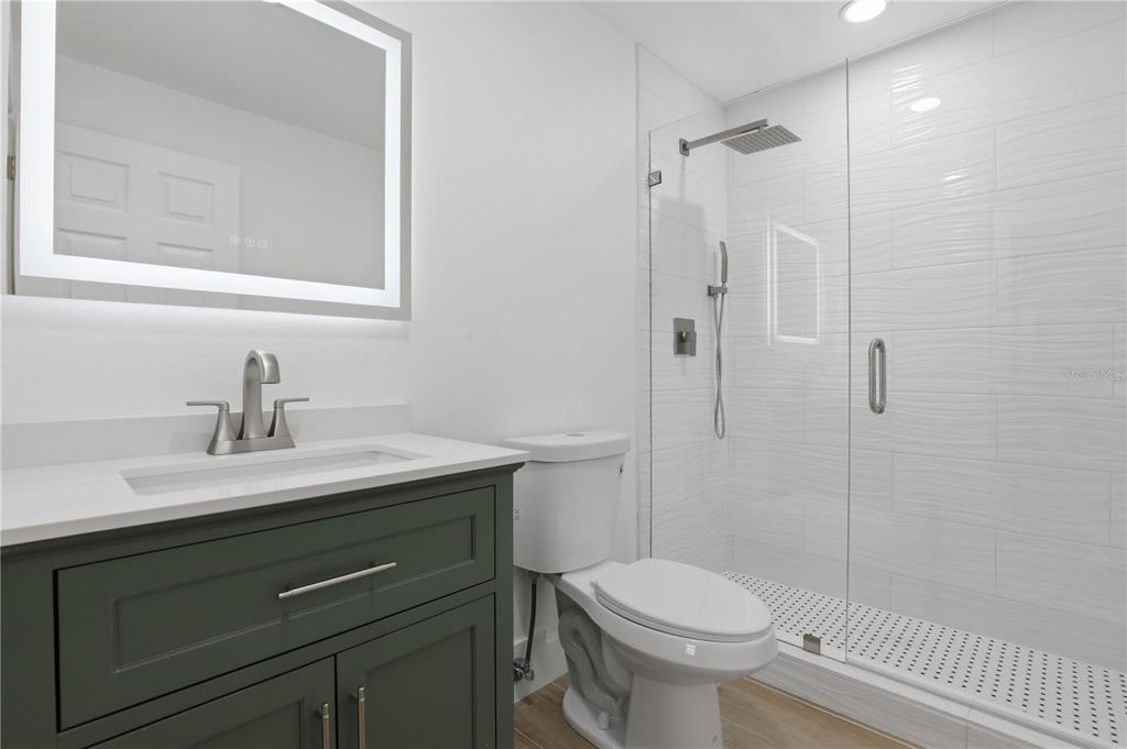 4460 Oakley Street Punta Gorda, FL 33980 - Photo 13 of 18 a bathroom with a sink toilet and shower