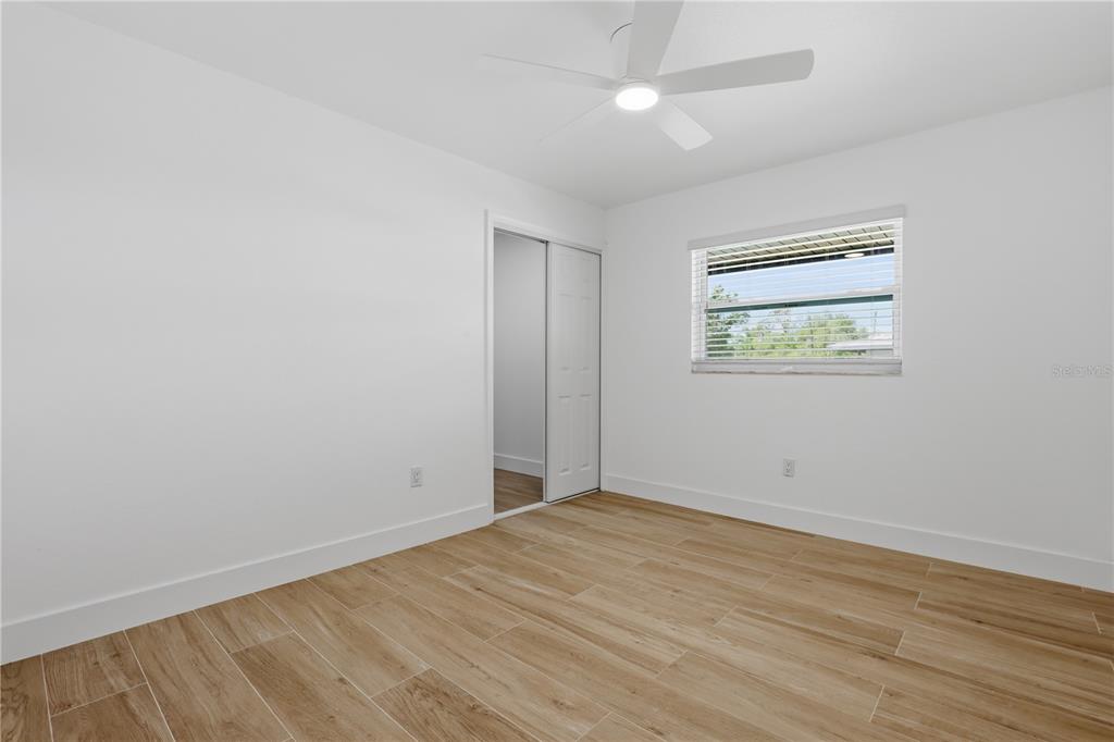 4460 Oakley Street Punta Gorda, FL 33980 - Photo 15 of 18 an empty room with wooden floor and windows