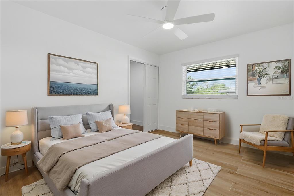 4460 Oakley Street Punta Gorda, FL 33980 - Photo 16 of 18 a bedroom with a bed and a chair
