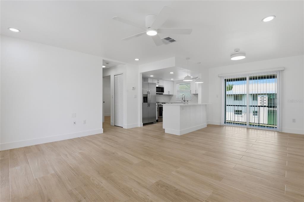 4460 Oakley Street Punta Gorda, FL 33980 - Photo 6 of 18 a view of an empty room with a window and wooden floor