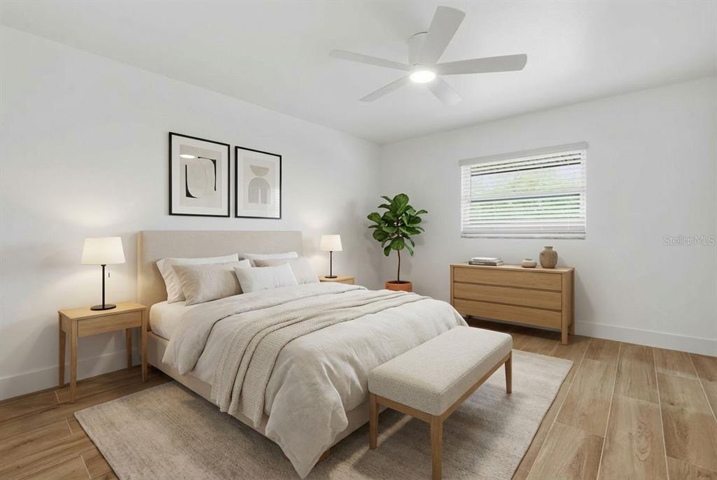 4460 Oakley Street Punta Gorda, FL 33980 - Photo 10 of 18 a bedroom with bed and a chandelier
