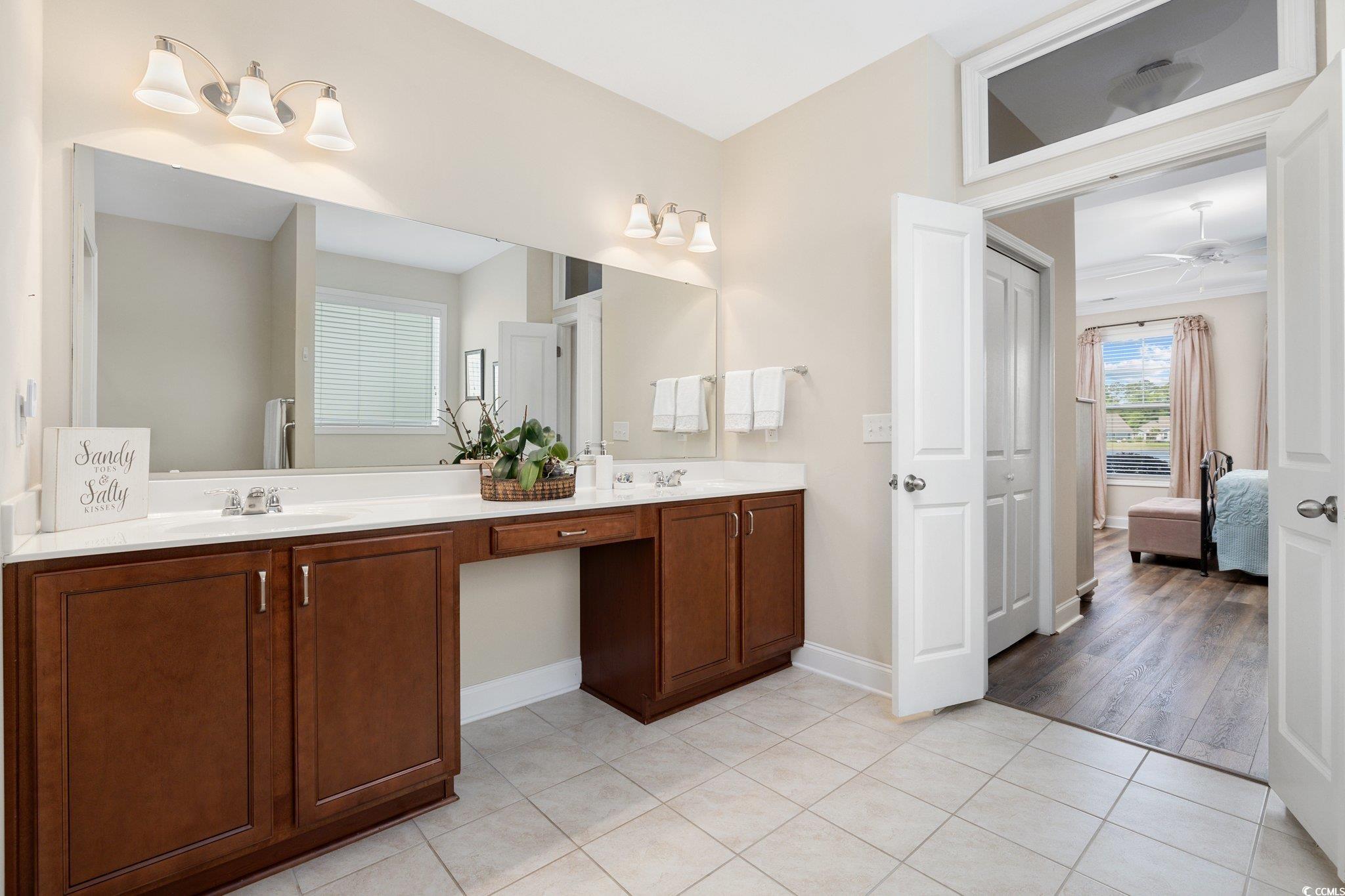 179 Hyacinth Loop Murrells Inlet, SC 29576 - Photo 14 of 40 Bathroom with connected bathroom, ceiling fan, a sink, double vanity, and tile patterned floors