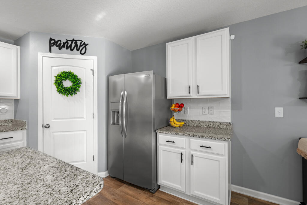 969 Merganser Way Crestview, FL 32539 - Photo 20 of 44 a kitchen with stainless steel appliances granite countertop a refrigerator and a stove