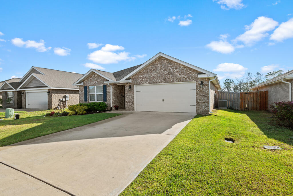 969 Merganser Way Crestview, FL 32539 - Photo 2 of 44 a view of a house with a yard and garage