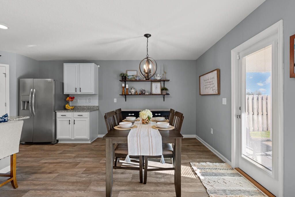 969 Merganser Way Crestview, FL 32539 - Photo 22 of 44 a view of a dining room with furniture a chandelier and wooden floor