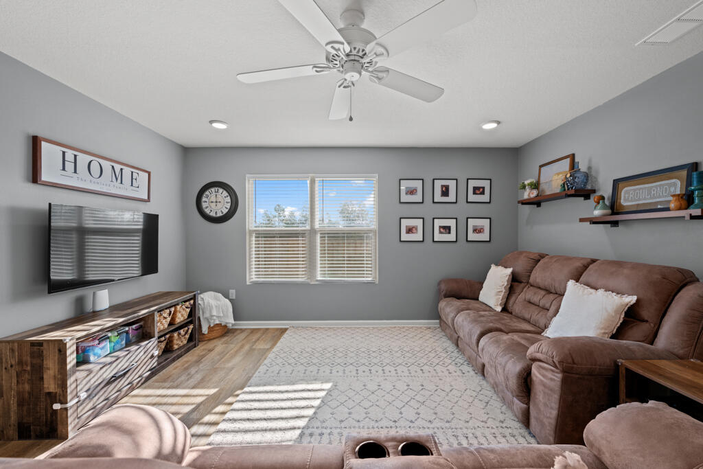969 Merganser Way Crestview, FL 32539 - Photo 25 of 44 a living room with furniture and a flat screen tv