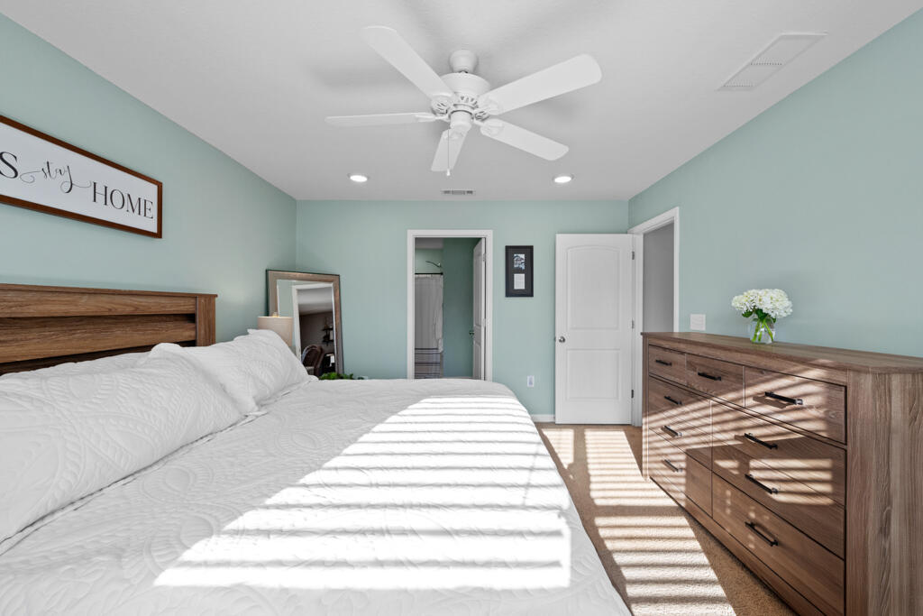 969 Merganser Way Crestview, FL 32539 - Photo 29 of 44 a bedroom with a bed and wooden floor