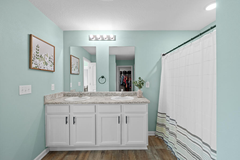 969 Merganser Way Crestview, FL 32539 - Photo 30 of 44 a bathroom with a granite countertop sink and a mirror