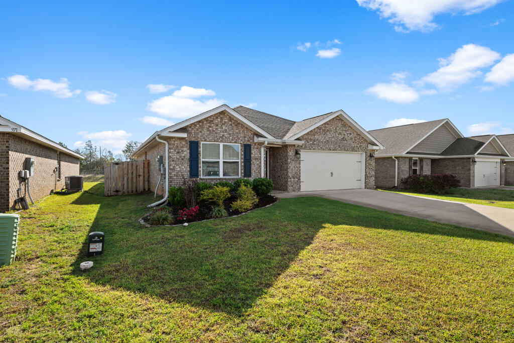969 Merganser Way Crestview, FL 32539 - Photo 3 of 44 a view of a house with a big yard plants and large tree