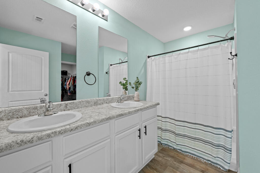 969 Merganser Way Crestview, FL 32539 - Photo 31 of 44 a bathroom with a granite countertop sink and a mirror