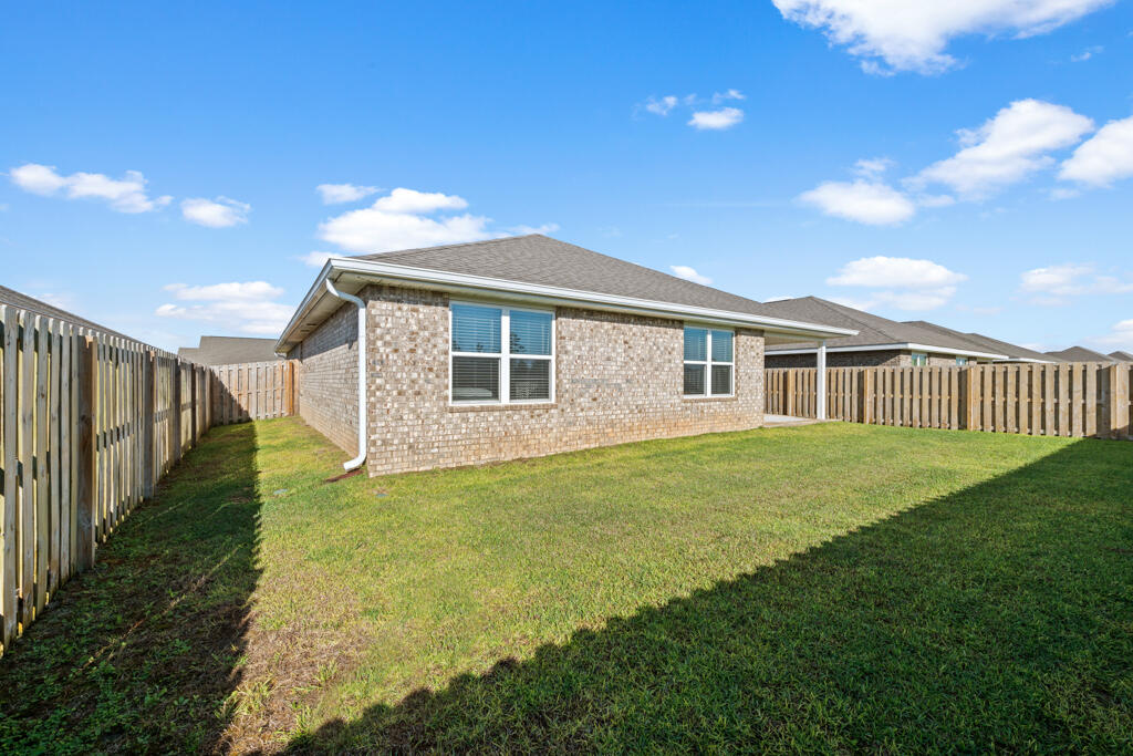 969 Merganser Way Crestview, FL 32539 - Photo 34 of 44 a view of a backyard with plants and large trees