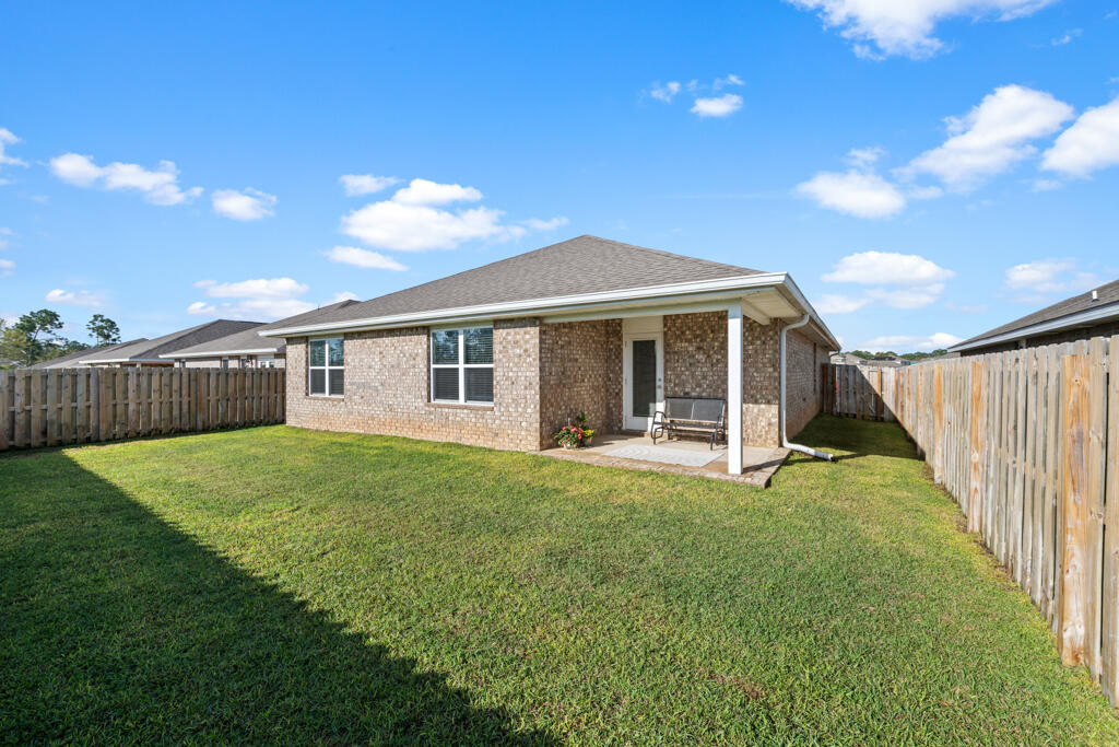 969 Merganser Way Crestview, FL 32539 - Photo 35 of 44 a view of a house with backyard and porch