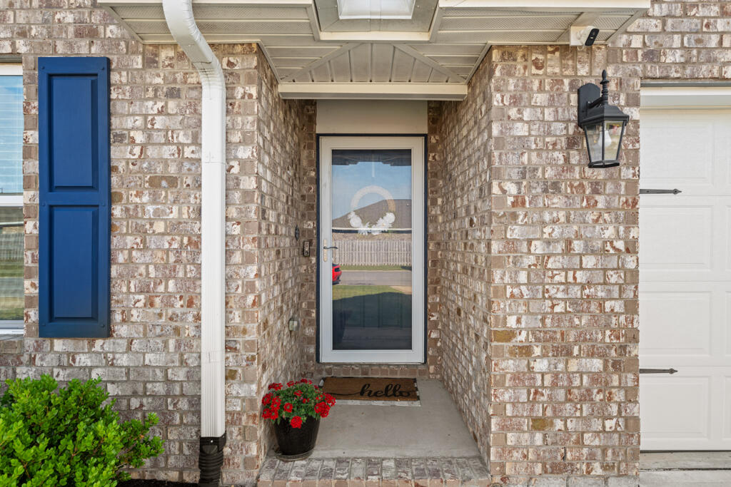 969 Merganser Way Crestview, FL 32539 - Photo 4 of 44 a front view of a house with a glass door