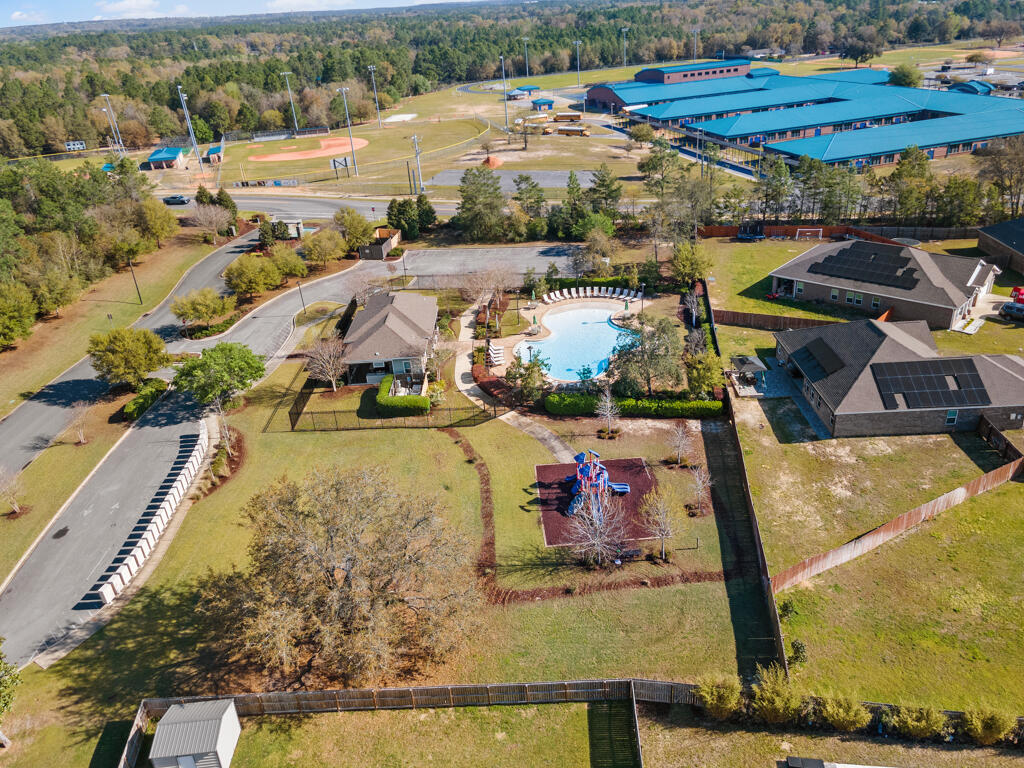 969 Merganser Way Crestview, FL 32539 - Photo 41 of 44 a view of a swimming pool with a table and chairs