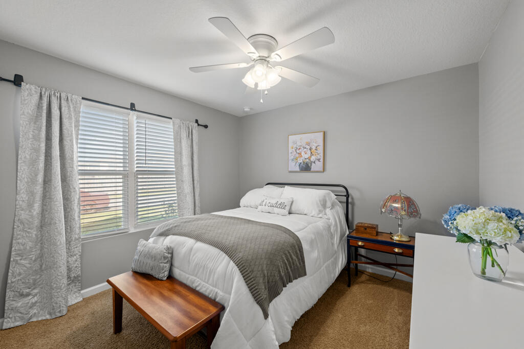 969 Merganser Way Crestview, FL 32539 - Photo 6 of 44 a bedroom with a bed and a chandelier