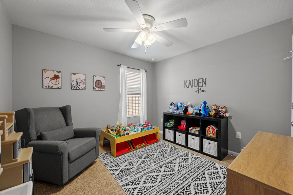 969 Merganser Way Crestview, FL 32539 - Photo 10 of 44 a living room with furniture and a baby crib