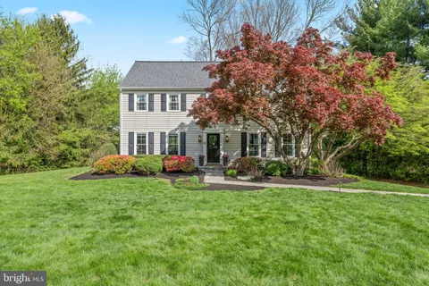a front view of a house with garden and porch