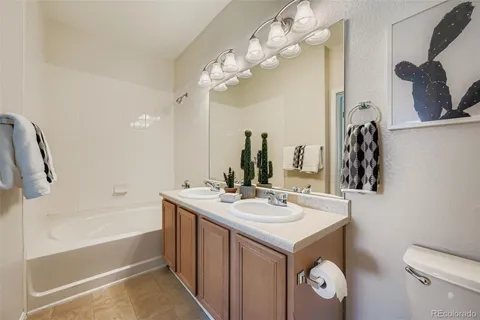 a bathroom with a sink vanity and a mirror