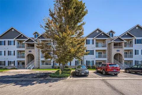 a car parked in front of a white house