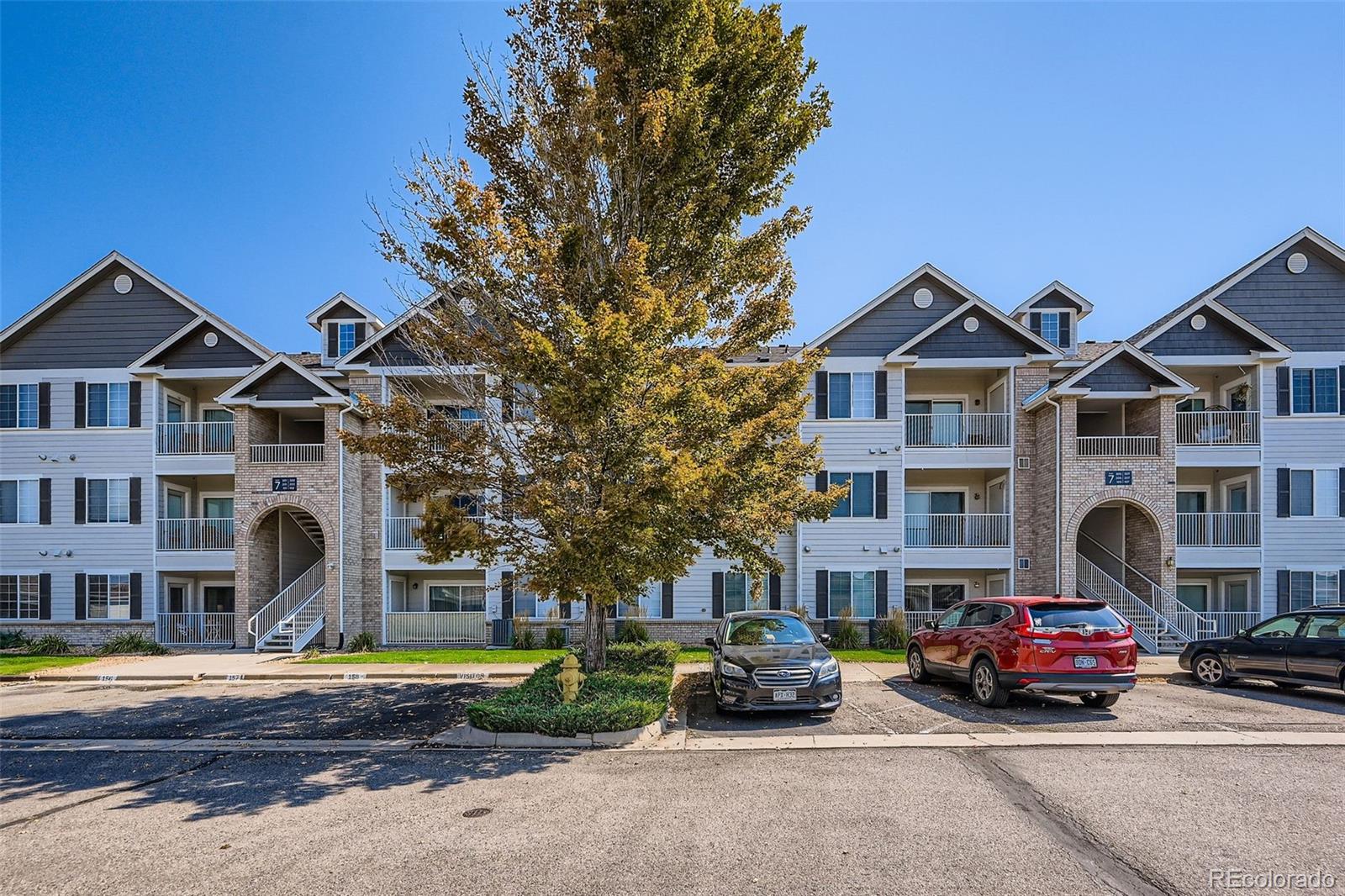 15700 East Jamison Drive, Unit 7101 Englewood, CO 80112 - Photo 23 of 31 a car parked in front of a white house