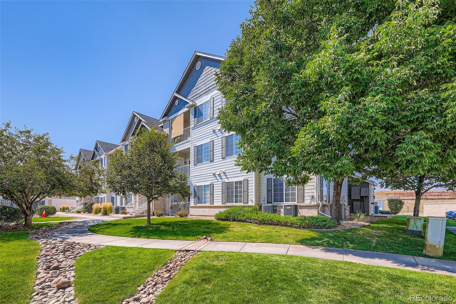 15700 East Jamison Drive, Unit 7101 Englewood, CO 80112 - Photo 25 of 31 a front view of a house with a yard