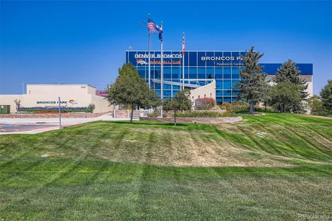 a view of a house with a yard and sitting area
