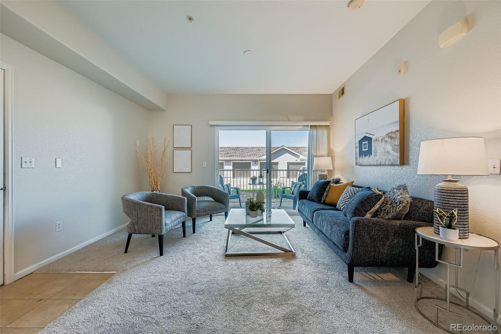 15700 East Jamison Drive, Unit 7101 Englewood, CO 80112 - Photo 4 of 31 a living room with furniture and a table
