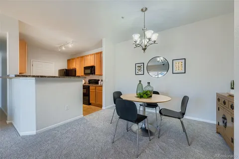 a view of a dining room with furniture and chandelier