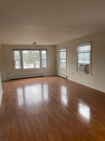 a view of a livingroom with an empty space and a fireplace