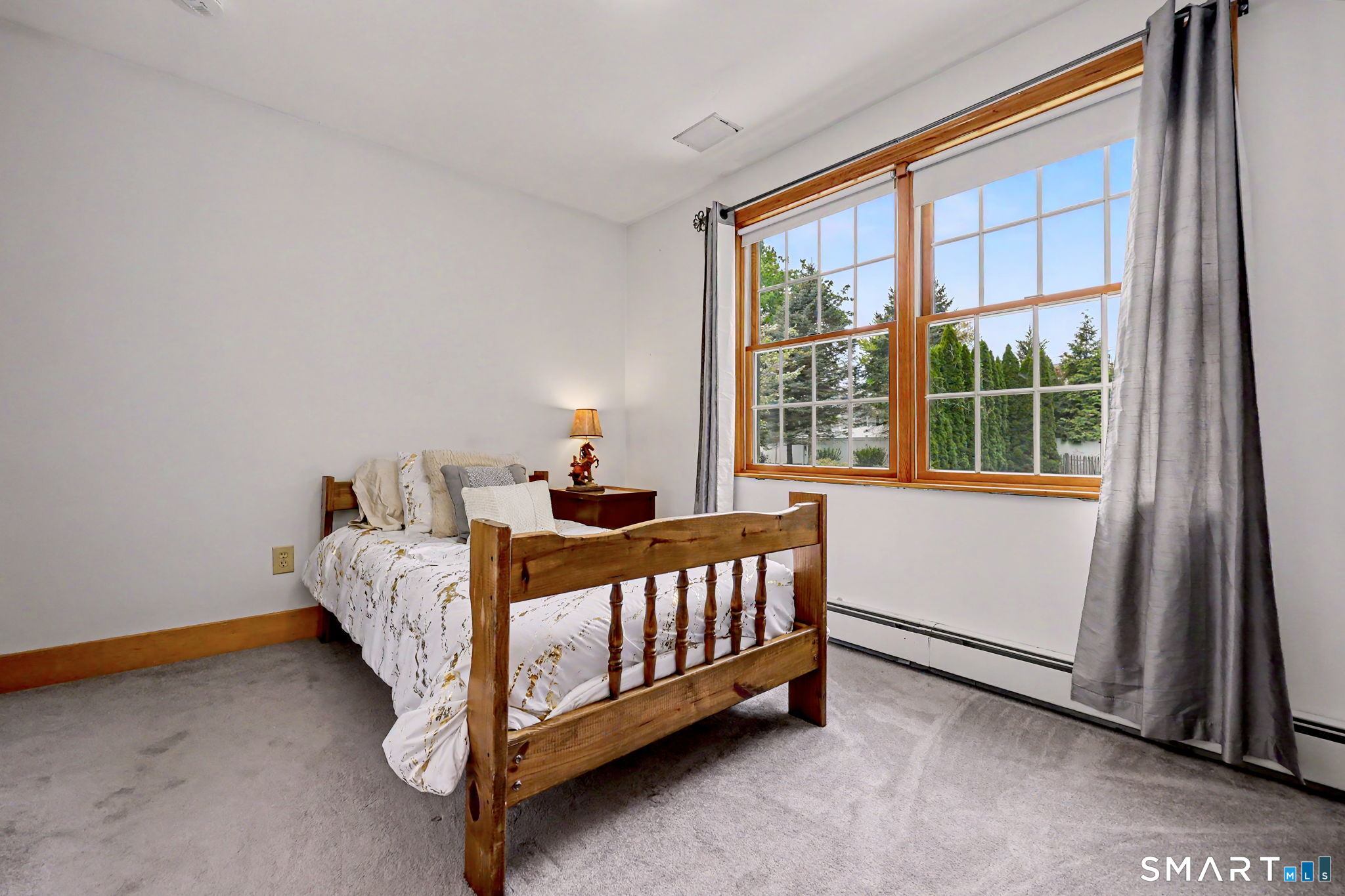 7 Merrill Road Trumbull, CT 06611 - Photo 29 of 40 a bed sitting in a bedroom next to a window
