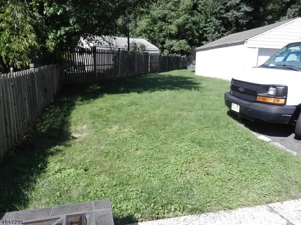 a view of a backyard with a garden and trees