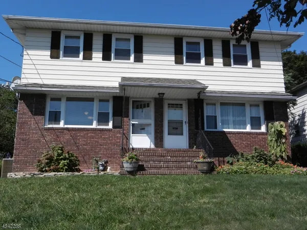 a view of a house with a yard and plants